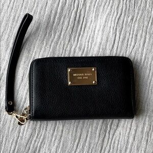 Michael Kors medium sized black zip around wallet with wrist strap